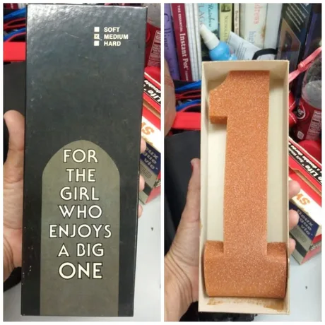 Two photos: a dark gift box reading "For the girl who enjoys a big one" with soft/medium/hard checkboxes, and the box opened to reveal a large orange number-1 shaped nail file.